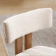 modern solid wood dining chairs with softly upholstered curved backrest and natural wood frame, close-up detail
