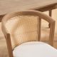modern farmhouse upholstered dining chairs featuring curved rattan backrest and smooth solid wood frame close-up
