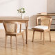 modern farmhouse upholstered dining chairs with woven rattan back and solid wood frame beside wooden dining table
