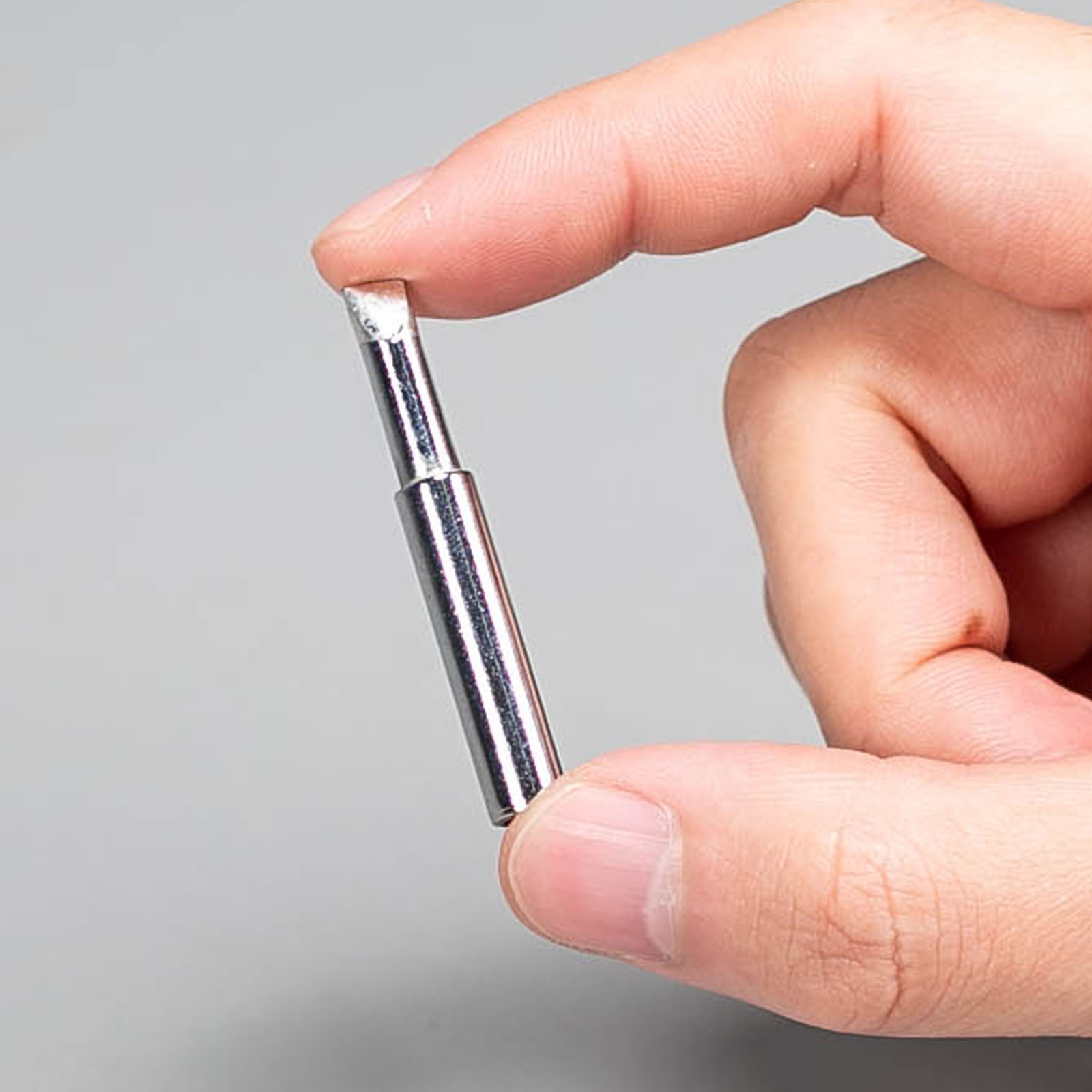 A hand holding a WEP 902 series 5.2D heavy-duty quick-heating soldering tip