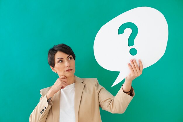 Free photo medium shot woman posing with question mark