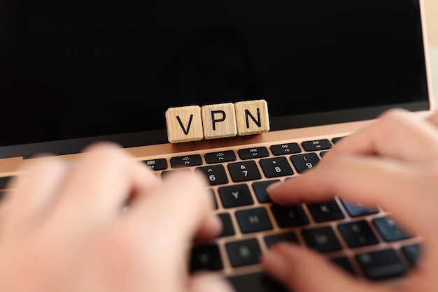 Photo internet user works on laptop with vpn virtual private network for secure and encrypted