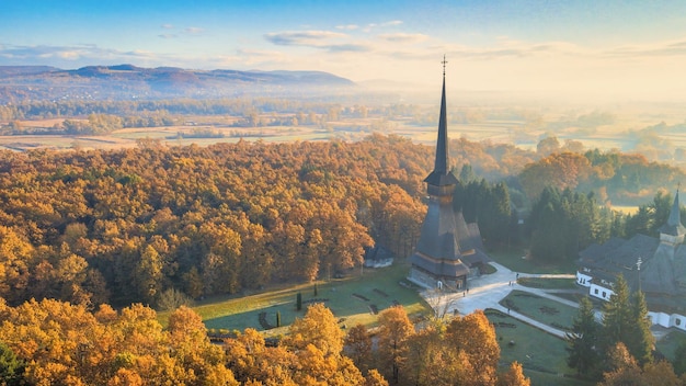 Free photo aerial drone view of the peri-sapanta monastery at sunrise, romania