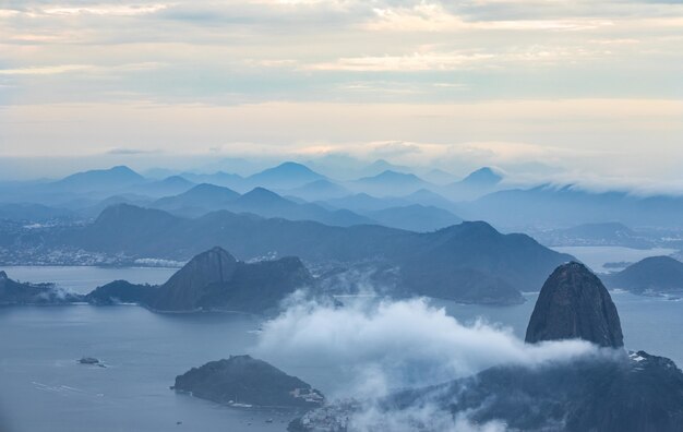 Free photo bird's eye view of an ocean with mountains surrounded by clouds