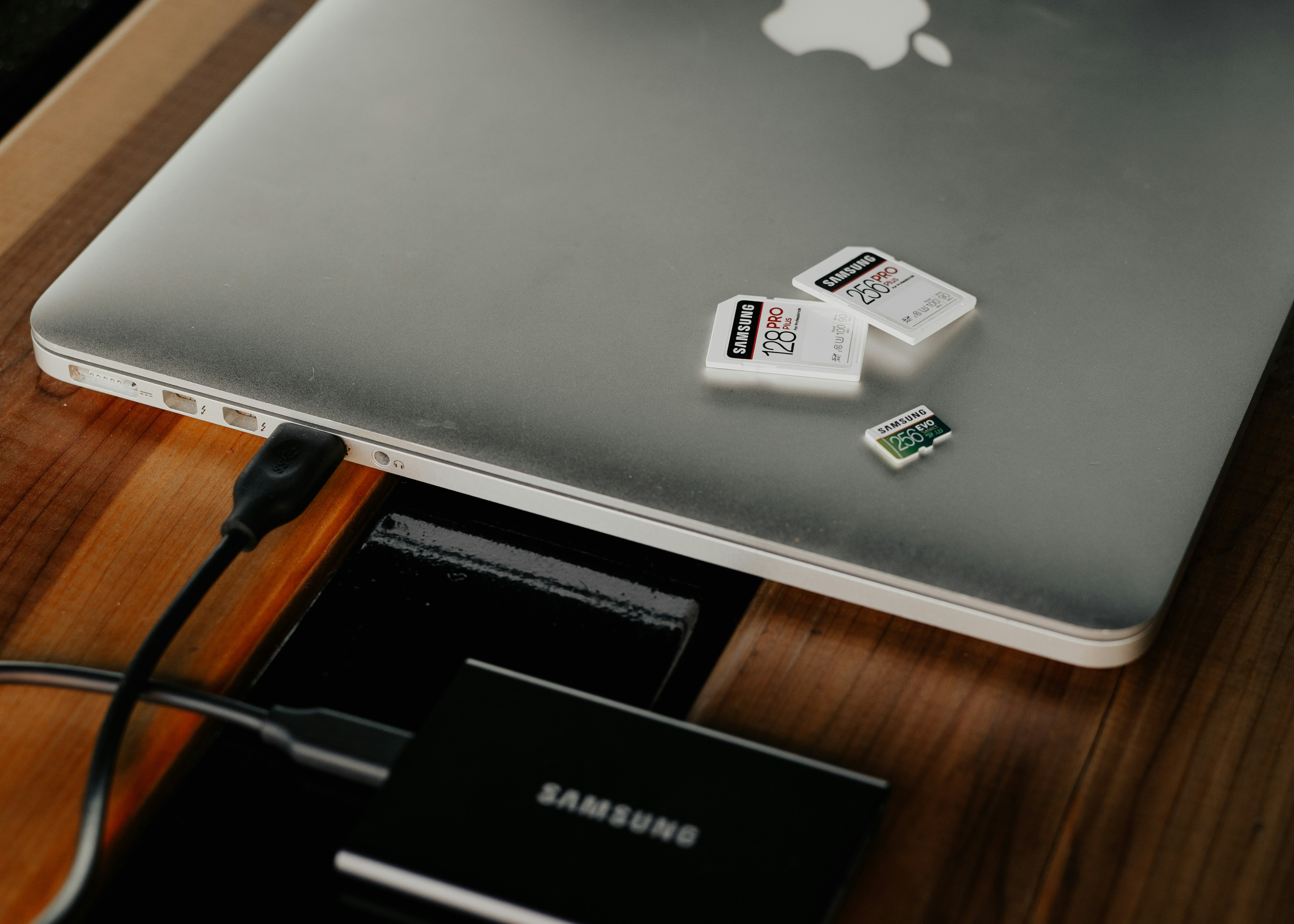 Small external device resting on a silver MacBook
