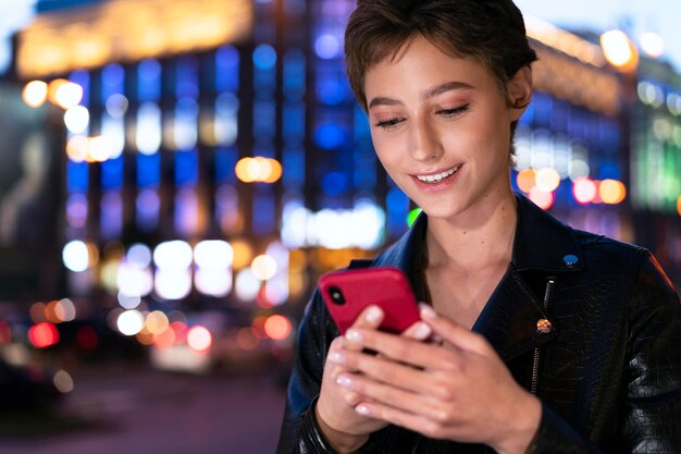 Free photo close up woman holding smartphone