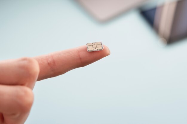Photo close-up sim card on fingertip