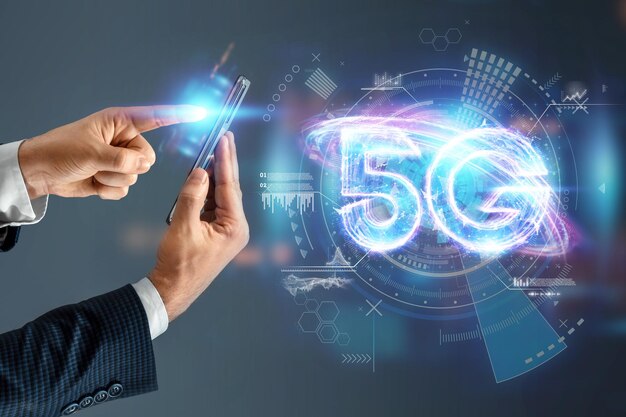 Photo creative background, a man's hand holds a phone with a 5g hologram on the background of the city. 5g network concept, high speed mobile internet, new generation networks. mixed media.