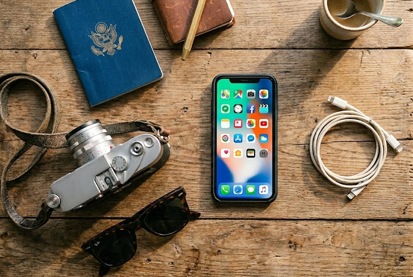 Travel essentials with a smartphone showing data-hungry apps for usage calculation
