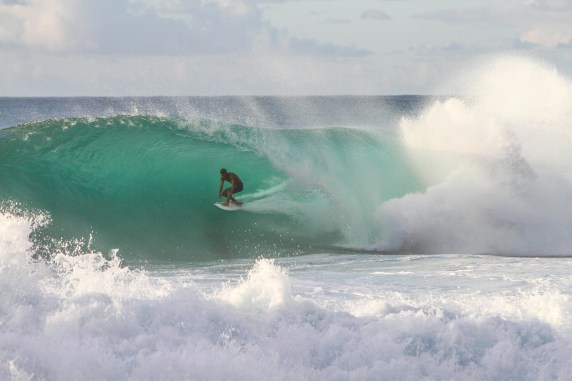 Surfer in the foaming water. North Shore, Waialua, United States