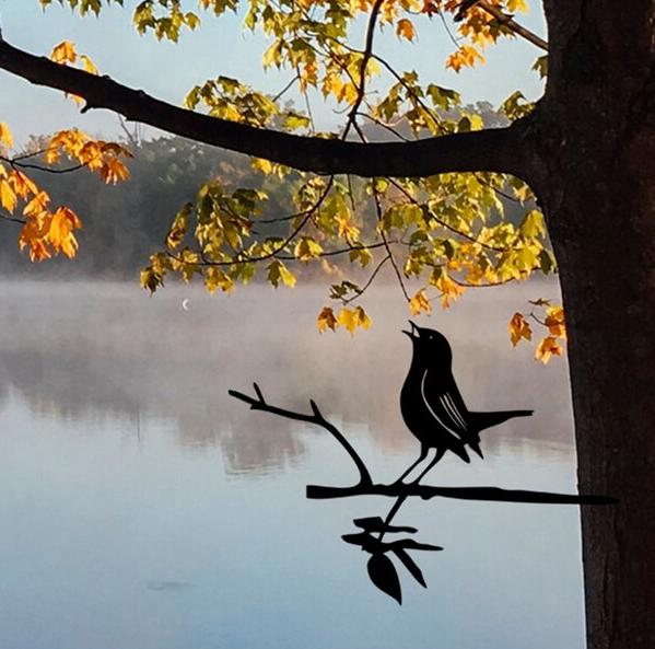 Metal bird on a branch