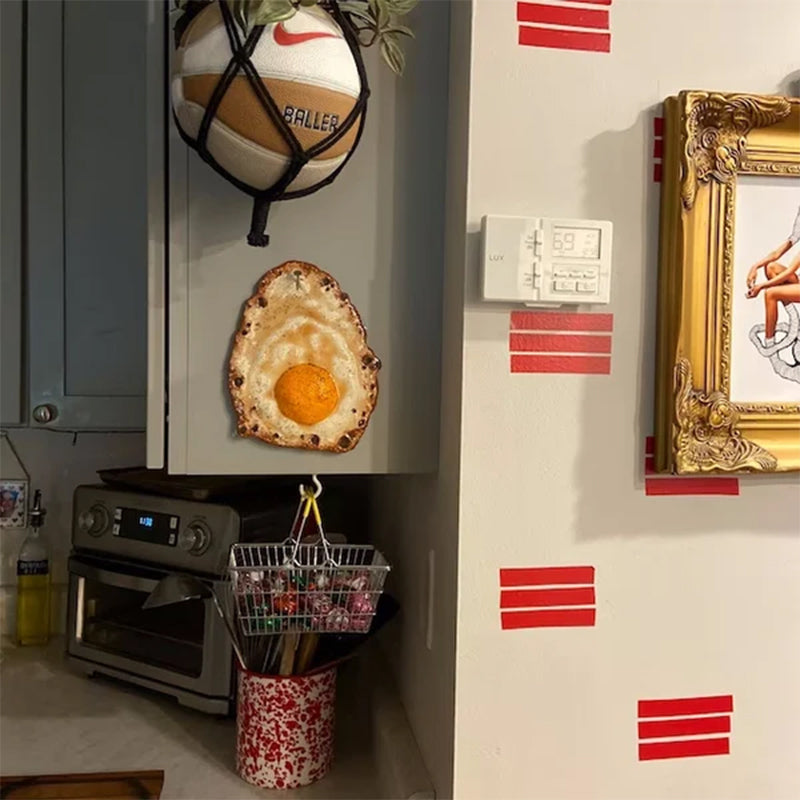 Fried Egg Hanging on a Nail