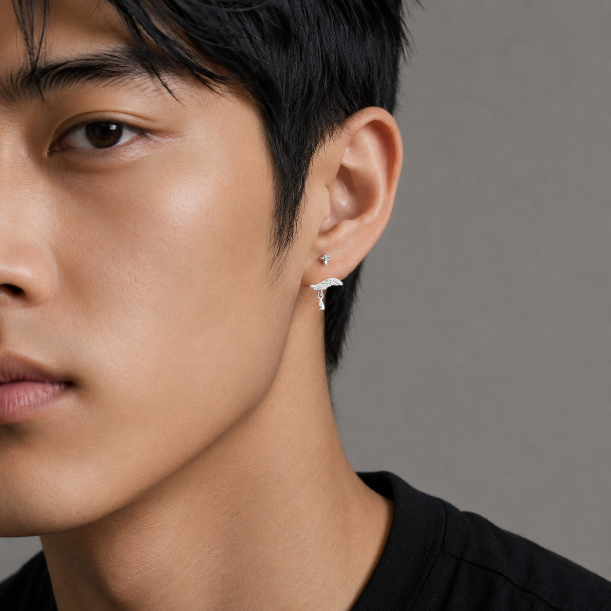 Angel N°2 Ear Studs worn on a man ear, wing and drop detail