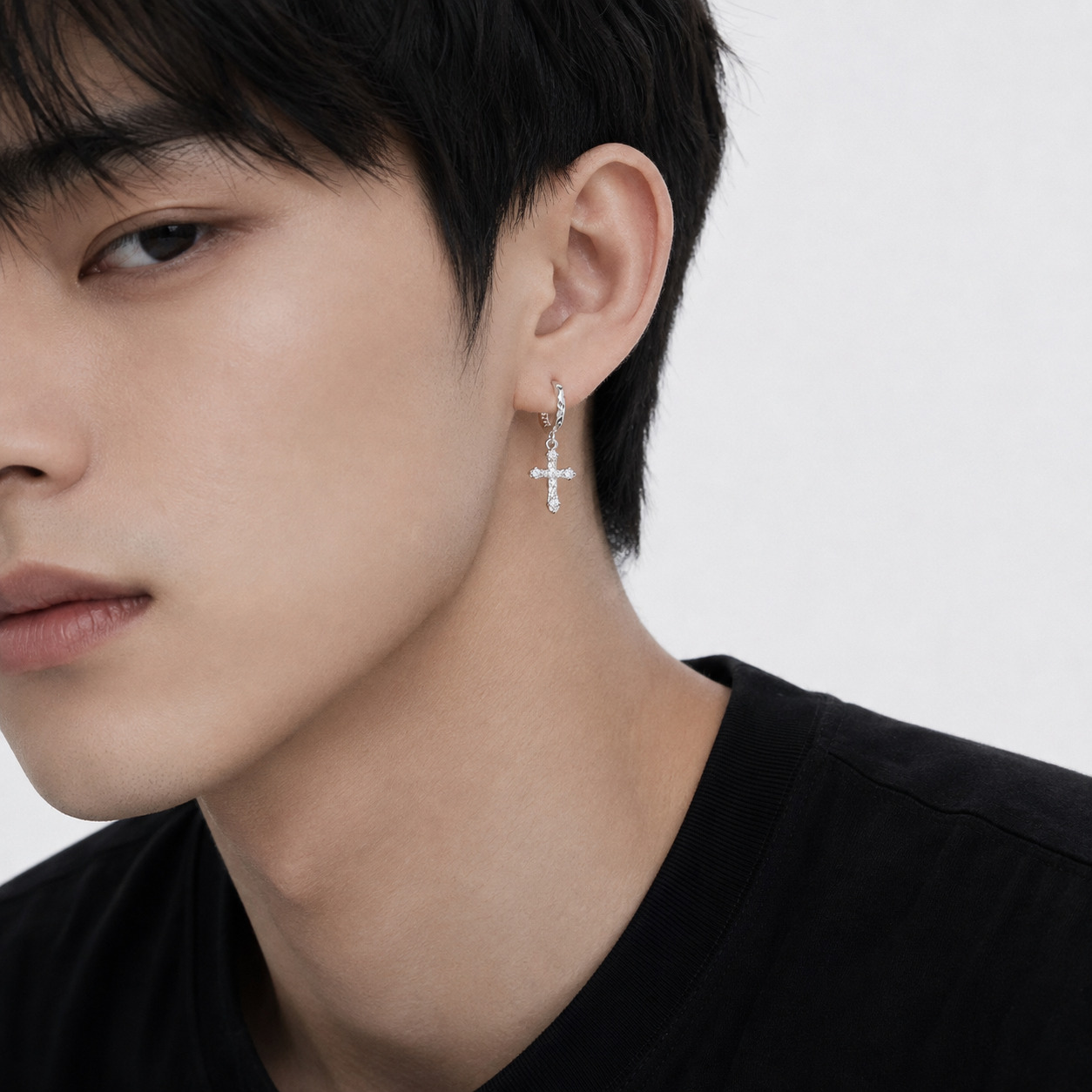 Christina N°1 Ear Hoops styled on a man's ear, hoop and cross detail