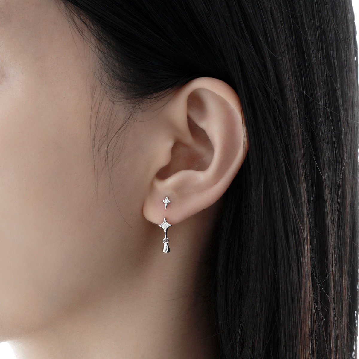 Starla N°6 star stud earring worn on ear, front angle
