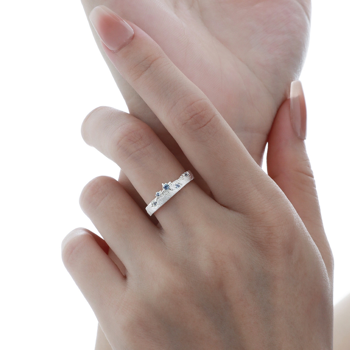 Close-up of Aqua Ring on hand, blue zircon detail