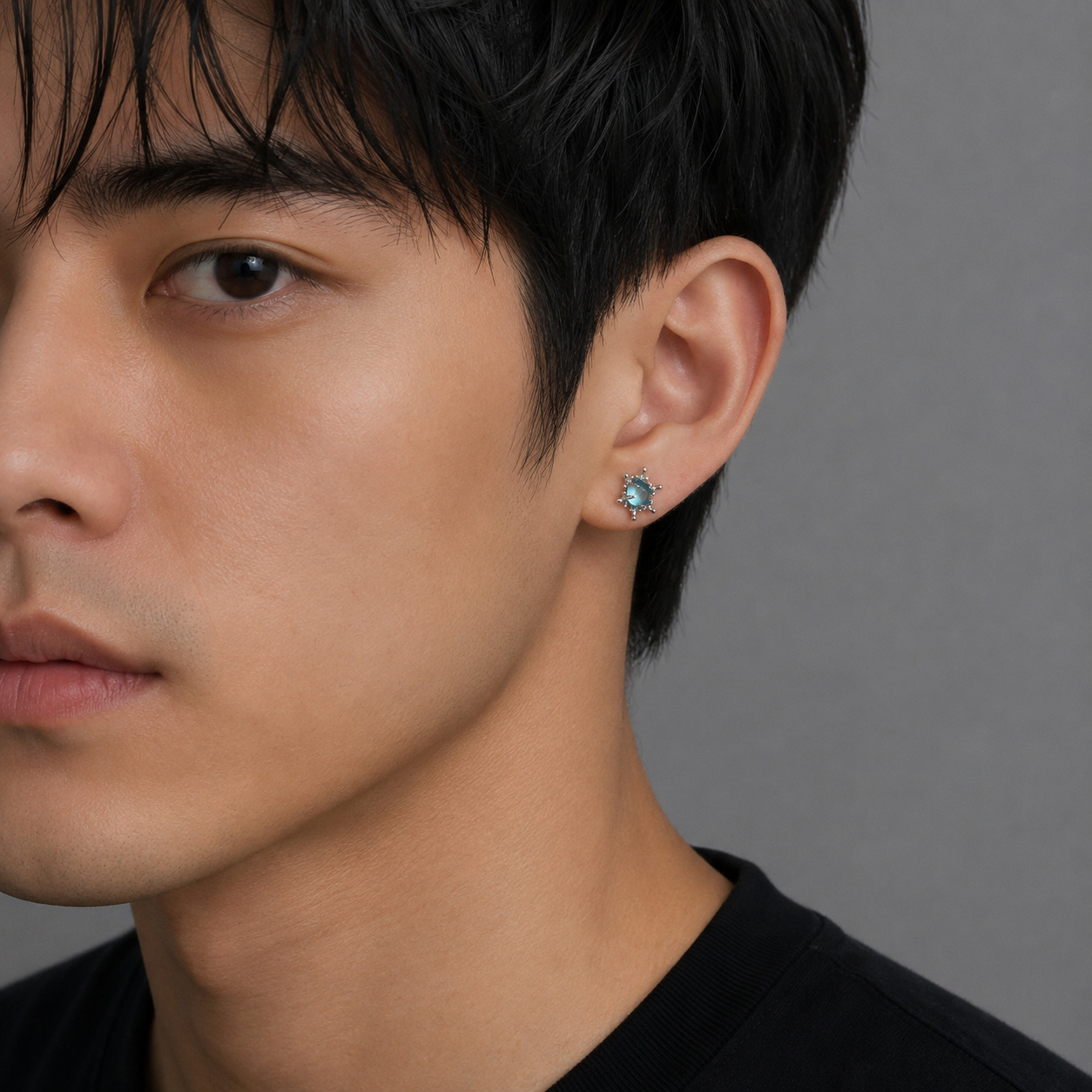 Blue crystal snowflake earring worn by male model