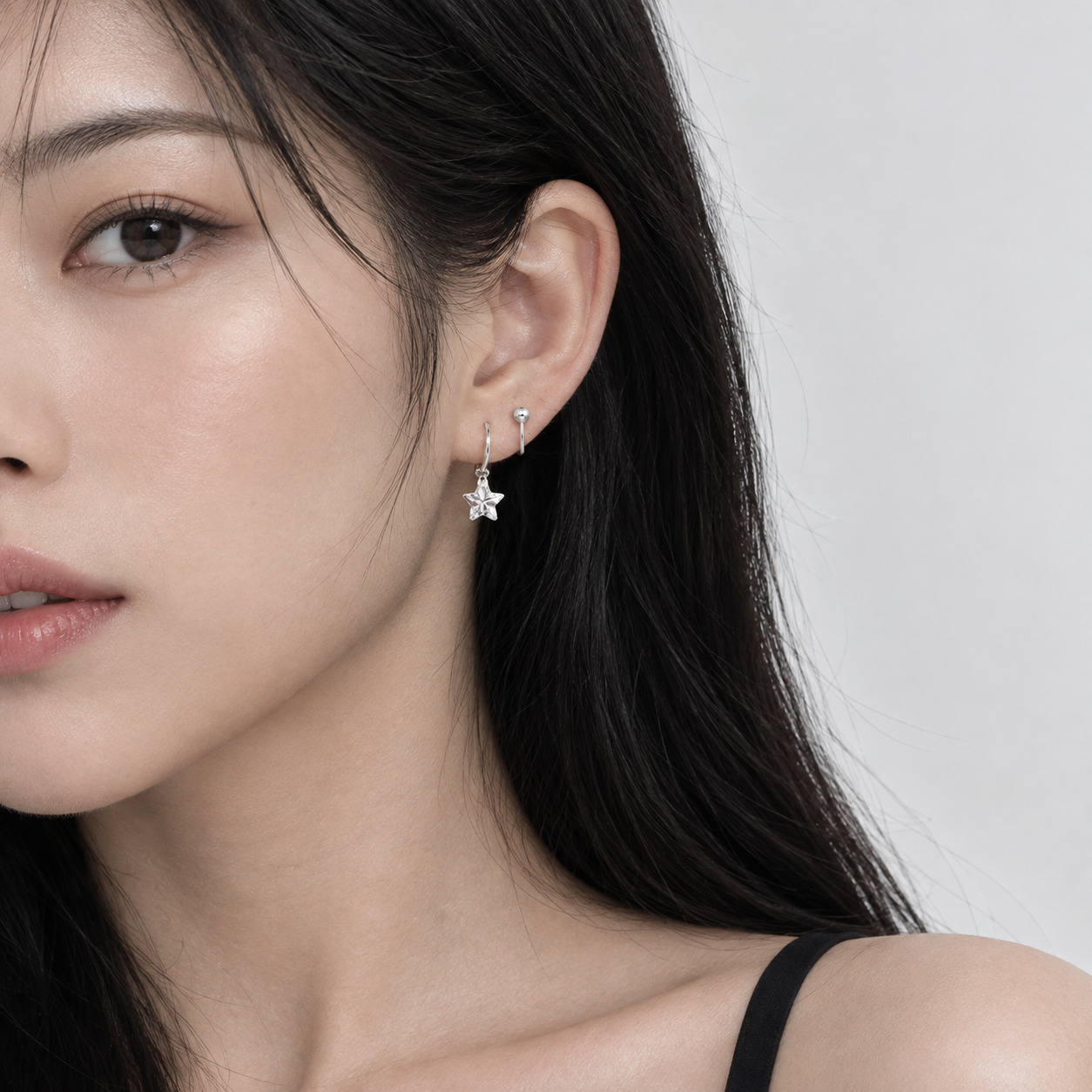 Celestial star drop earring worn by a female model