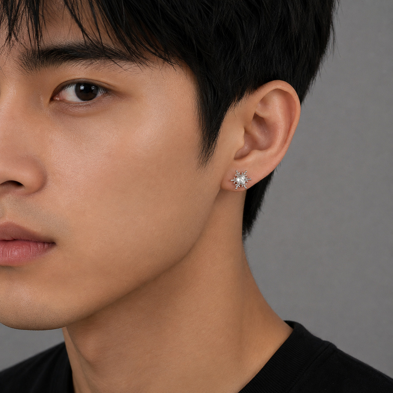 Crystal snowflake silver earring worn by male model