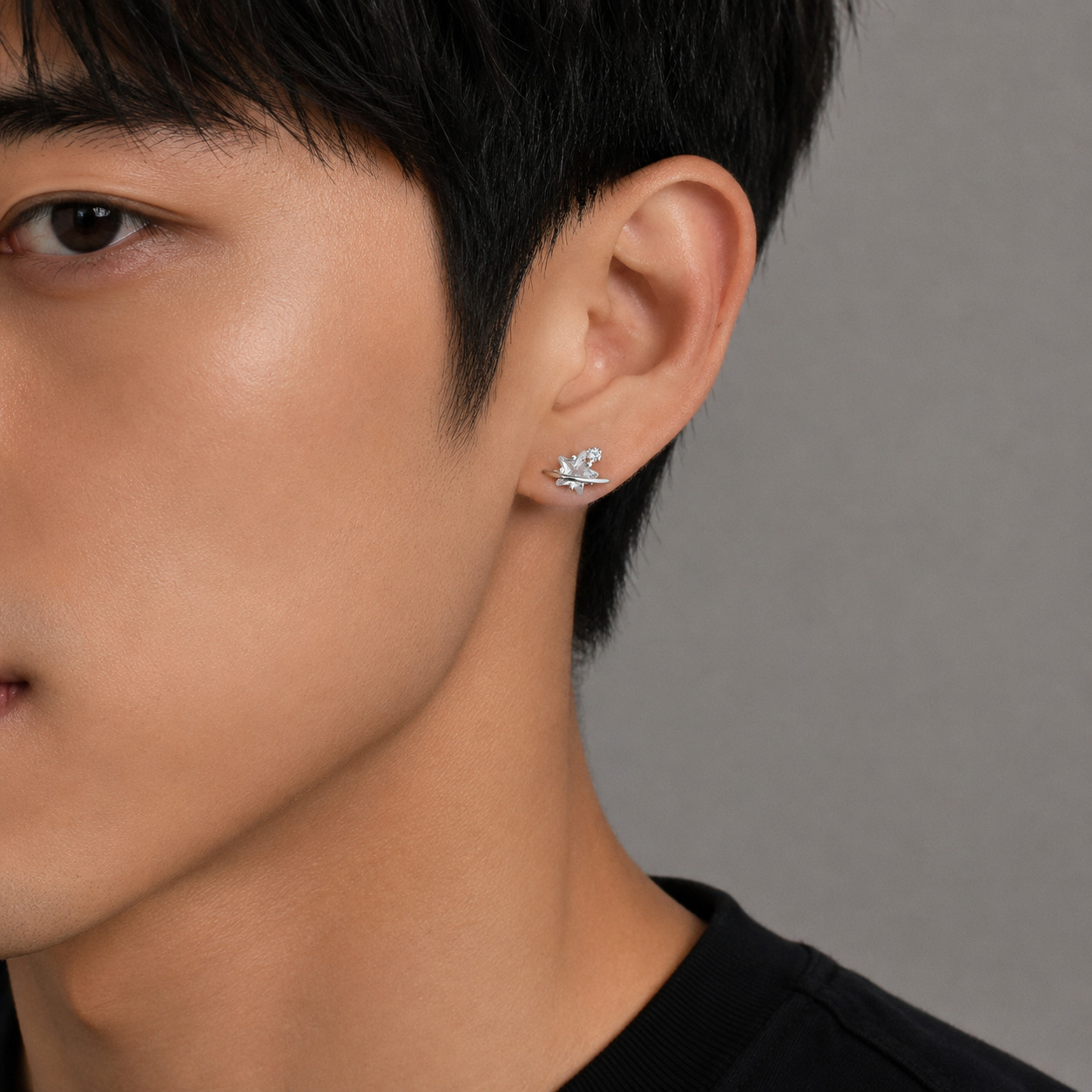 Dara N°3 925 sterling silver double star earrings styled on a a male model