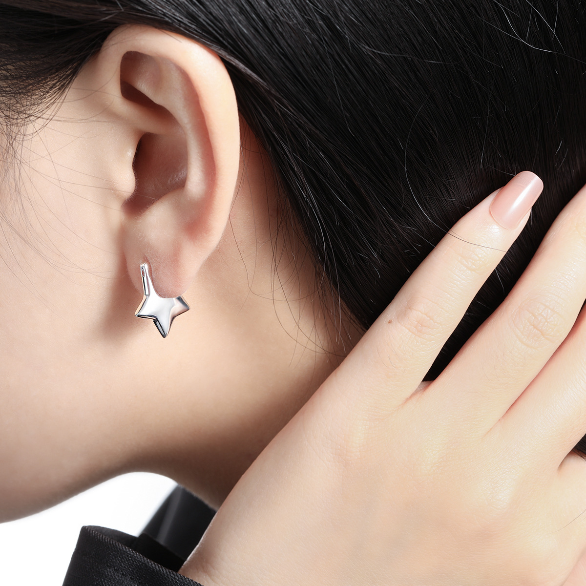 Close-up of Dara N°5 silver celestial star stud earring