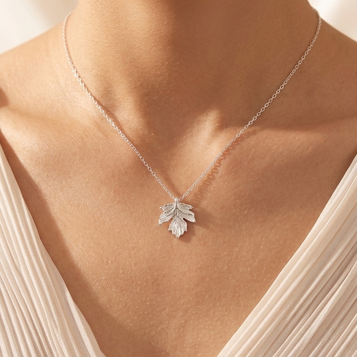 Maple leaf silver necklace worn by woman