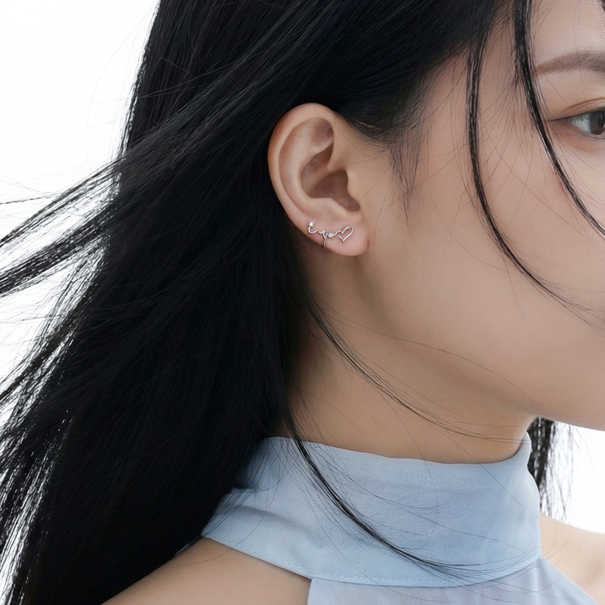 Heartbeat N°1 Ear Studs styled on ear, windblown hair