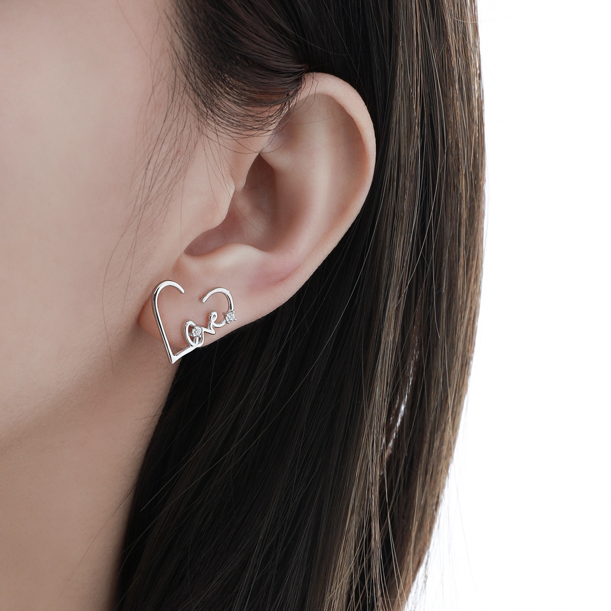 Woman wearing Heartbeat N°2 Ear Studs, heart outline detail
