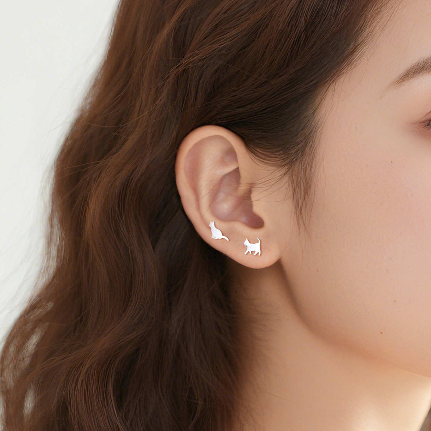Kitty N°3 Ear Studs worn on ear, standing and sitting cat detail