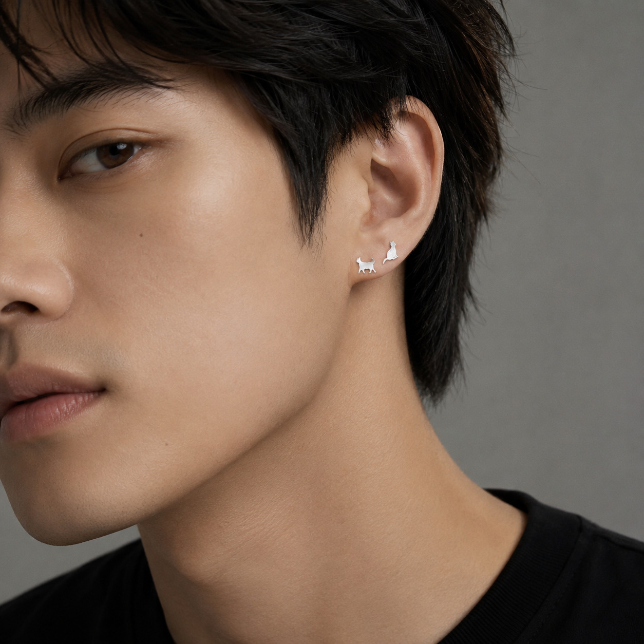 Man wearing Kitty N°3 Ear Studs, side profile view