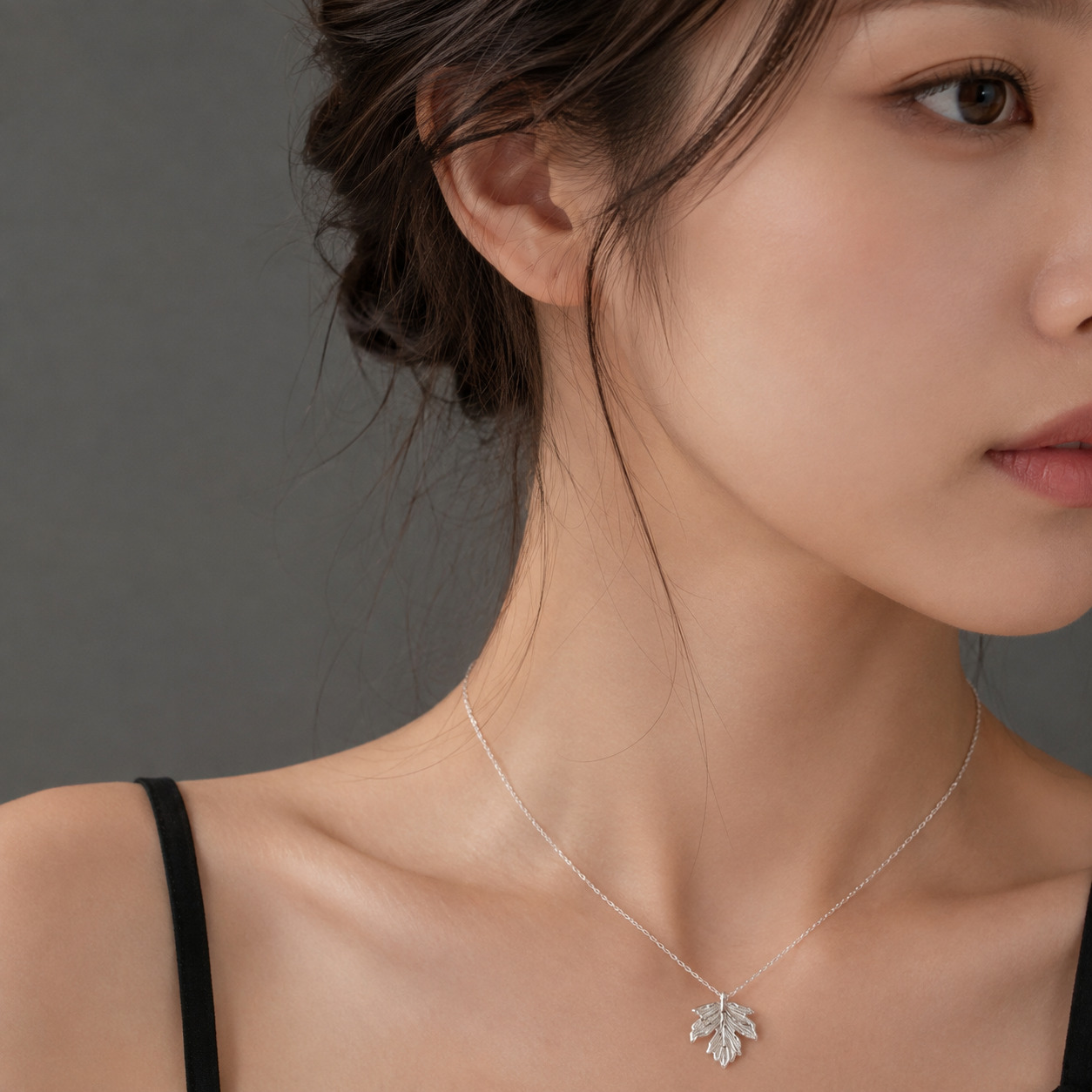 Maple leaf necklace worn by female model
