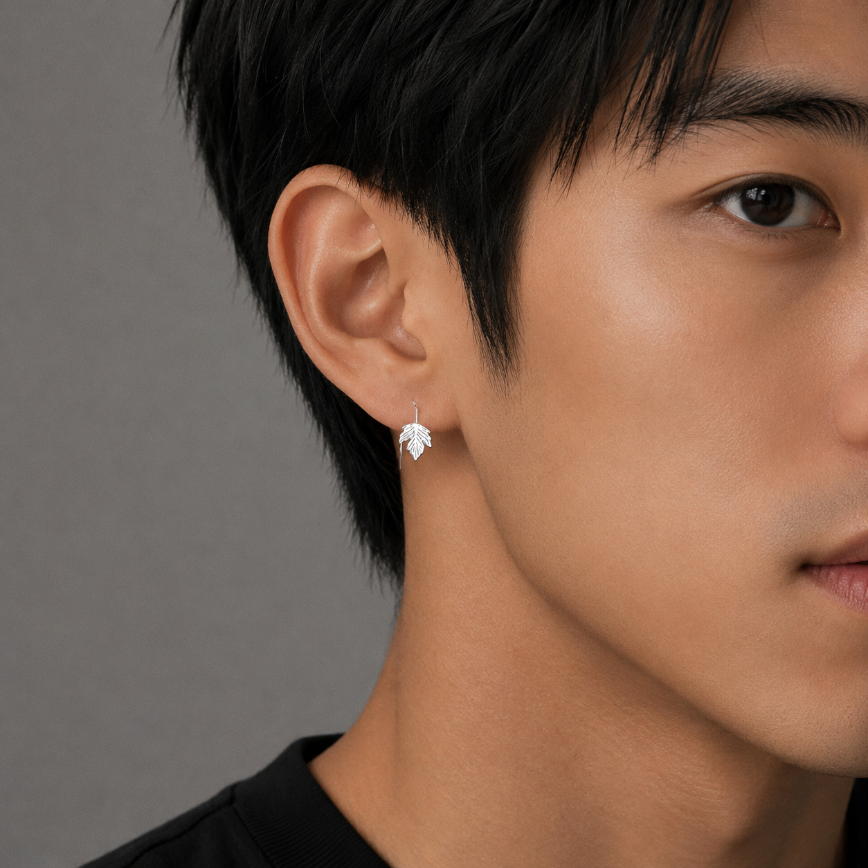 Maple silver ear studs worn by male model