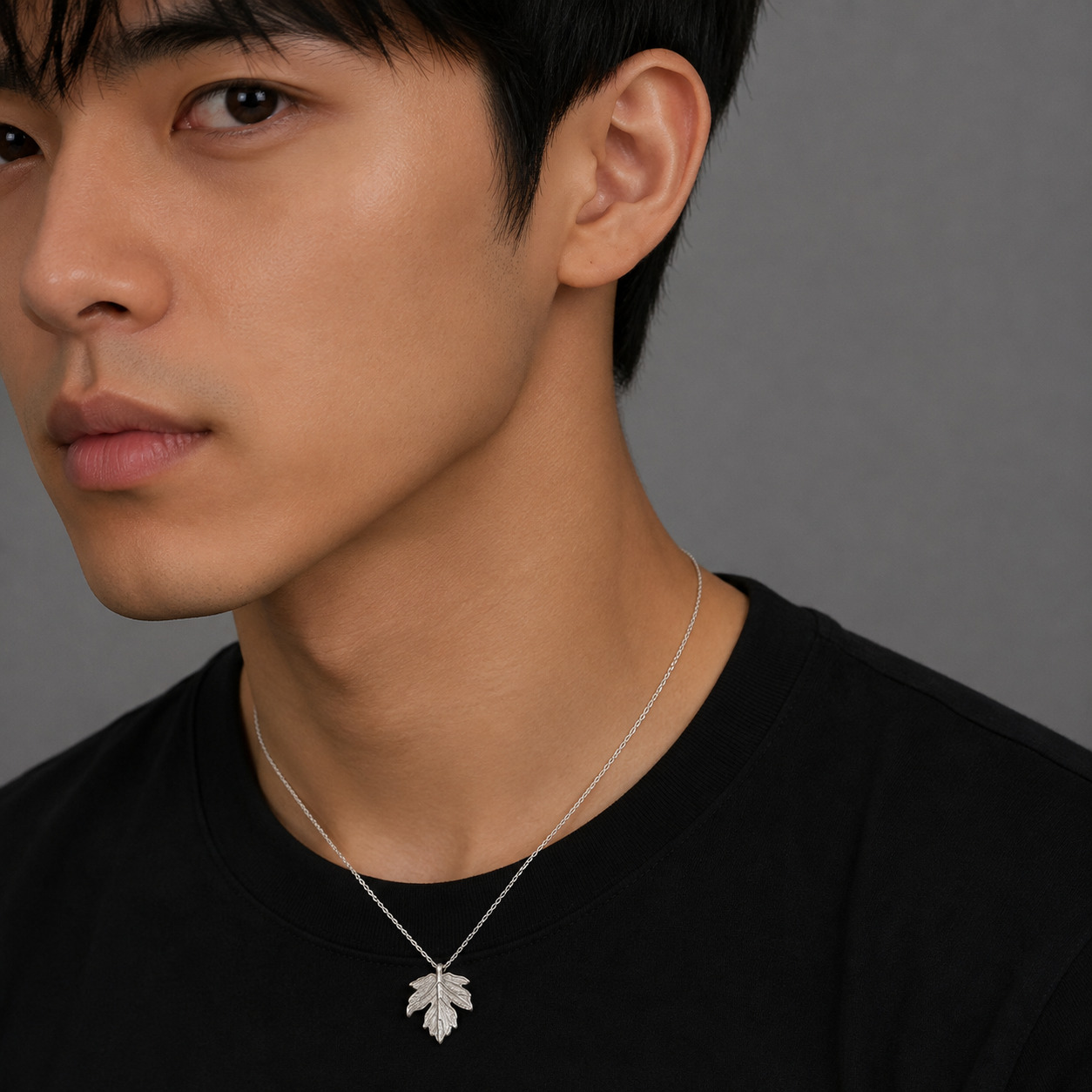 Maple leaf sterling silver necklace worn by male model