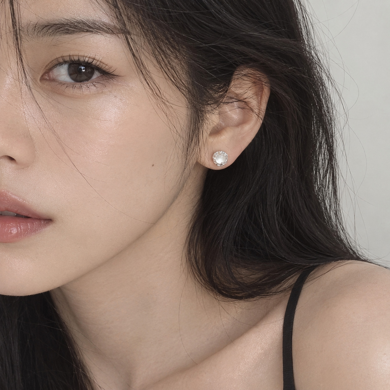 Moonstone silver ear stud worn by woman