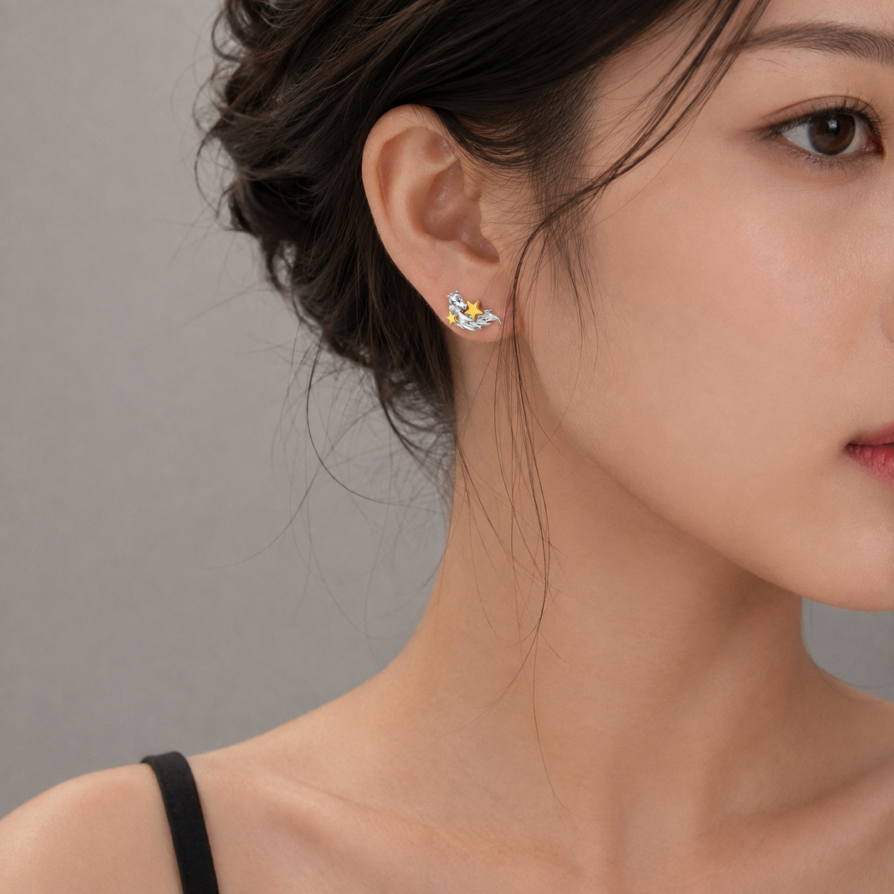 Horse inspired silver earrings worn by female model