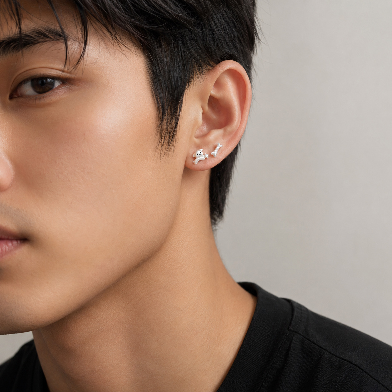 Puppy Ear Studs styled on a man's ear, sterling silver bone stud