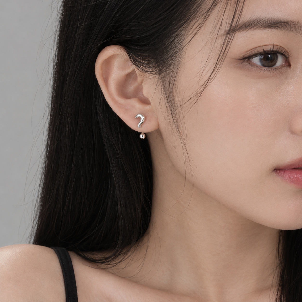 Silver question and exclamation mark inspired earrings on woman