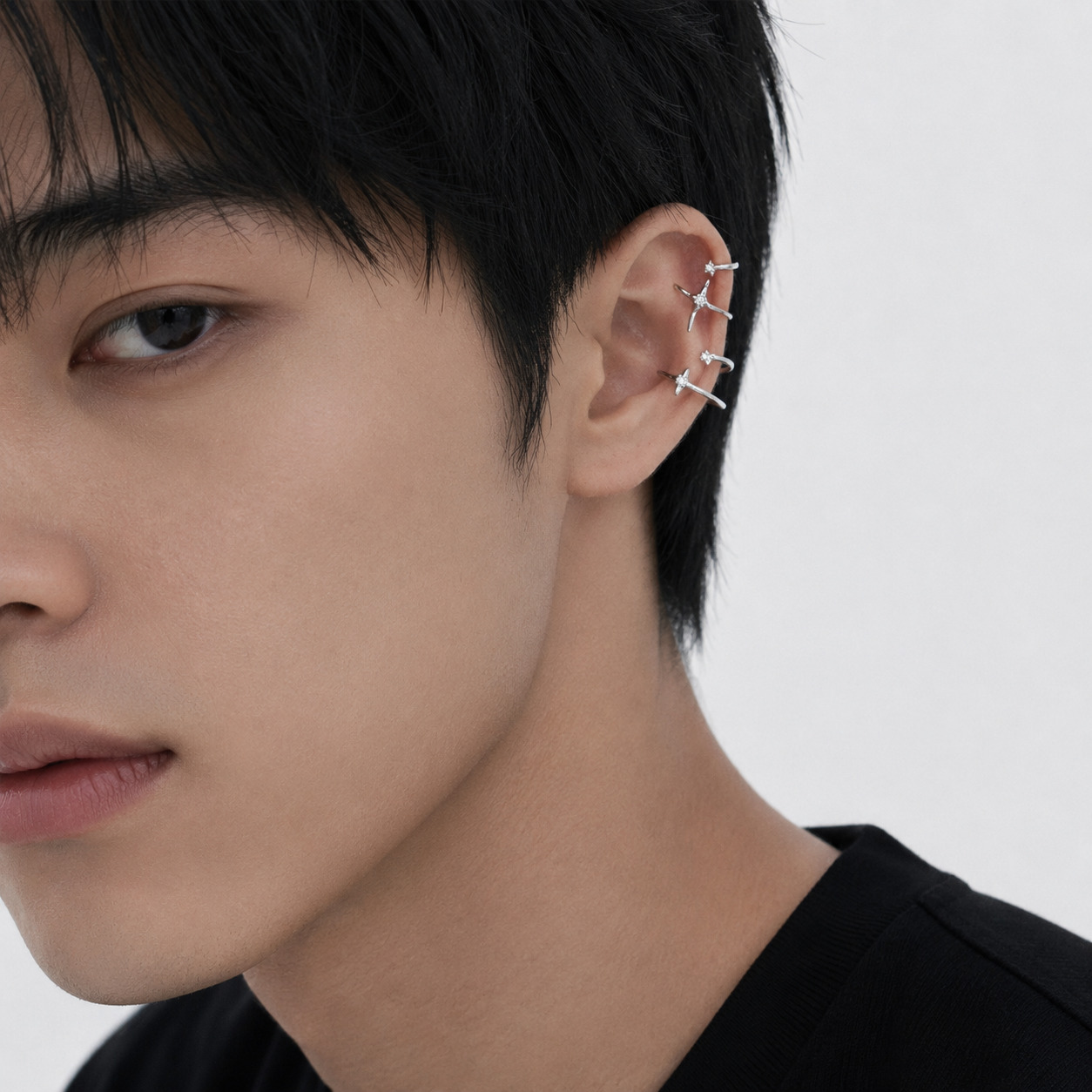 Starla Ear Cuff Combo styled on man ear layered star ear cuff stack without piercing
