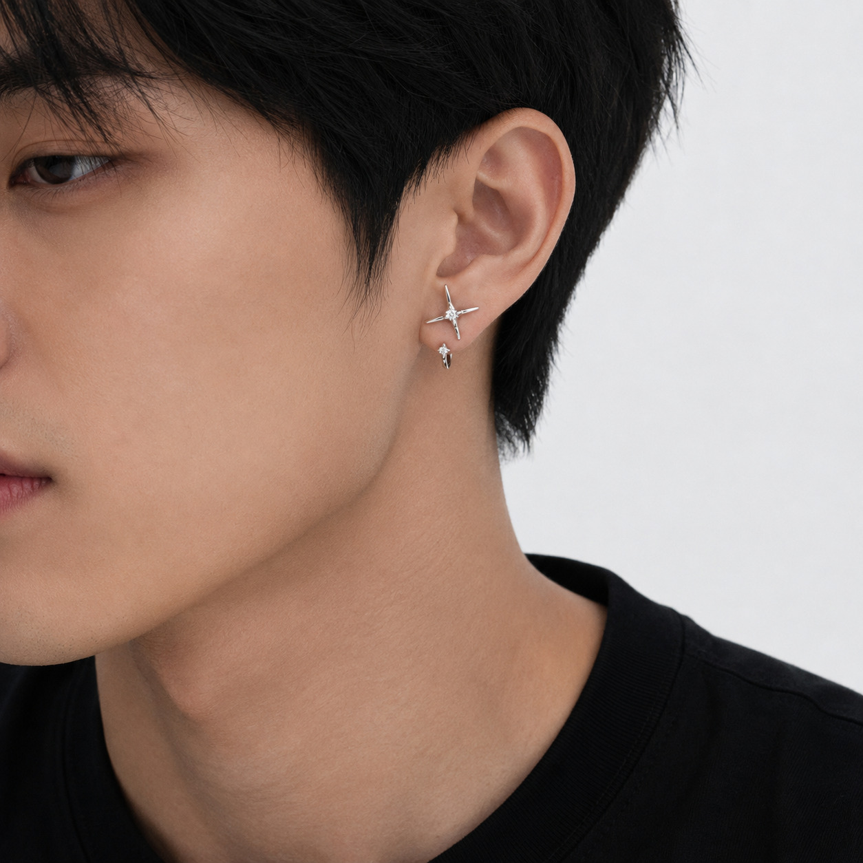 Side profile of male model wearing Starla N°4 sterling silver star threader earrings