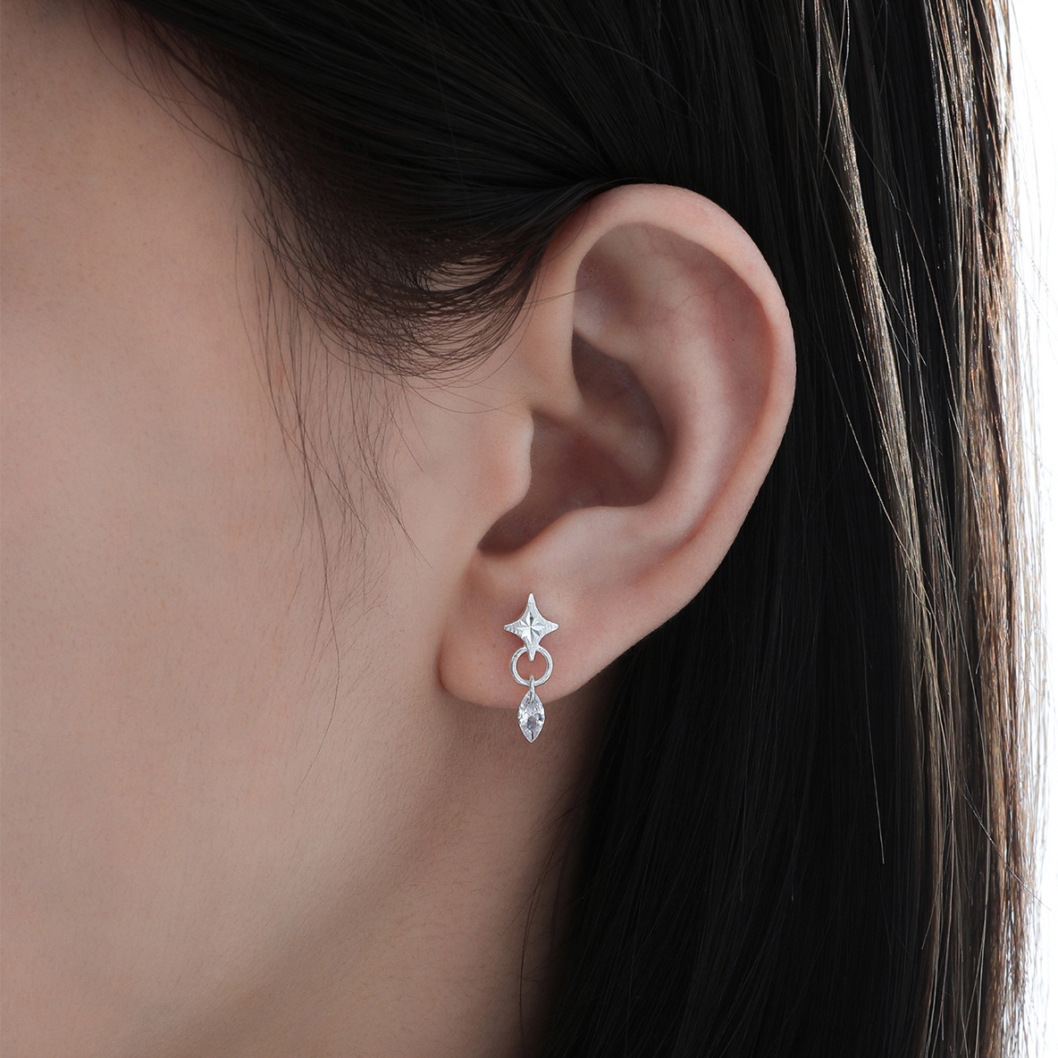 Starla N°7 star earrings worn on woman's ear