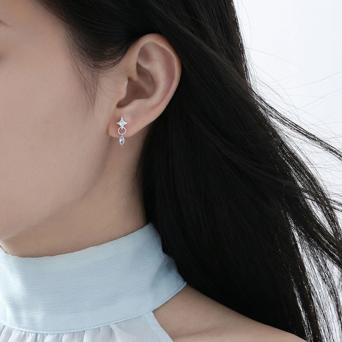 Starla N°7 long star earrings on ear