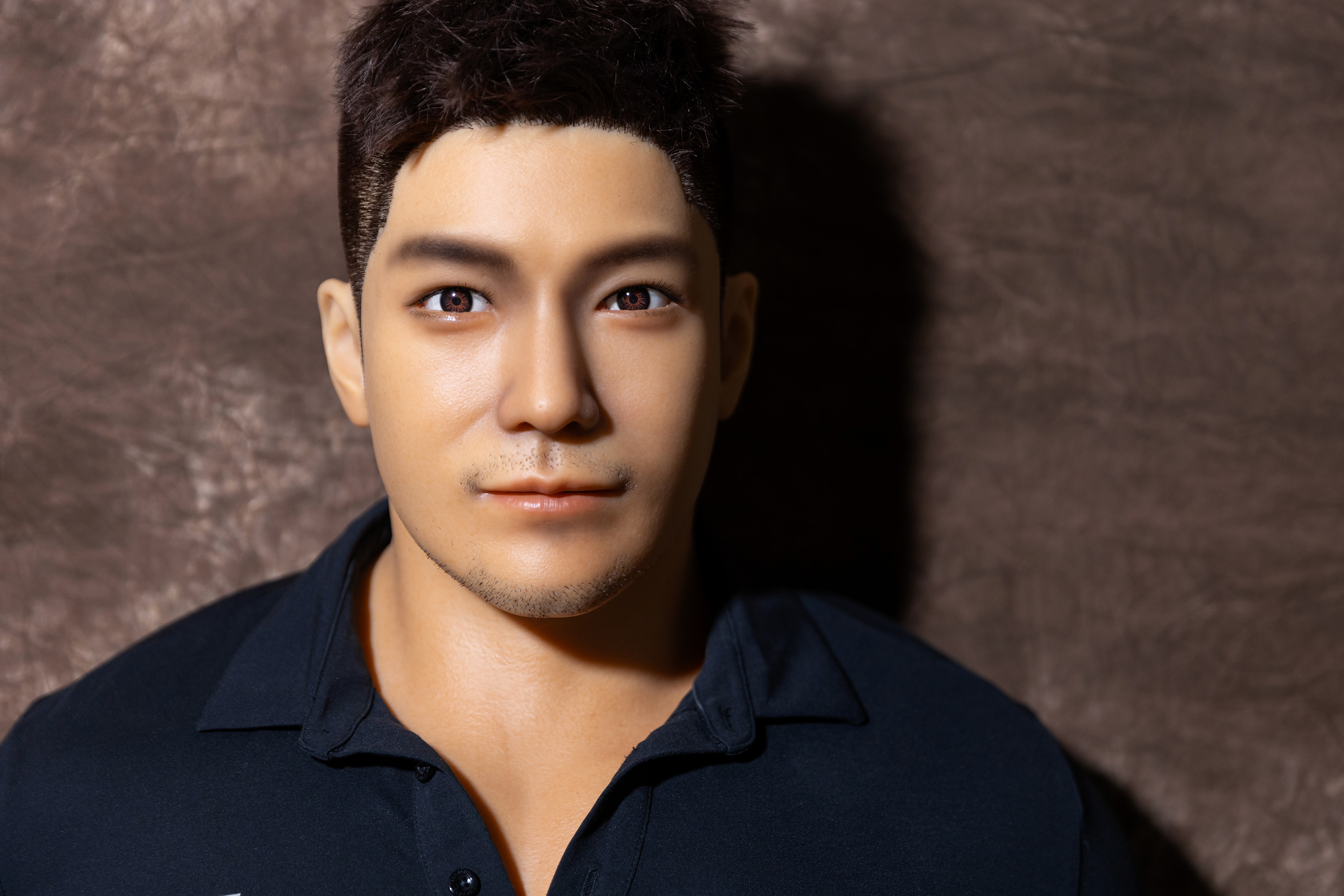 Close-up of male sex doll face.