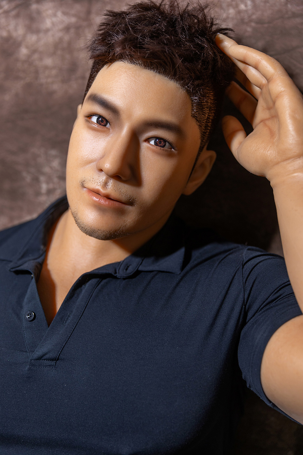 Male sex doll, close-up, navy polo shirt
