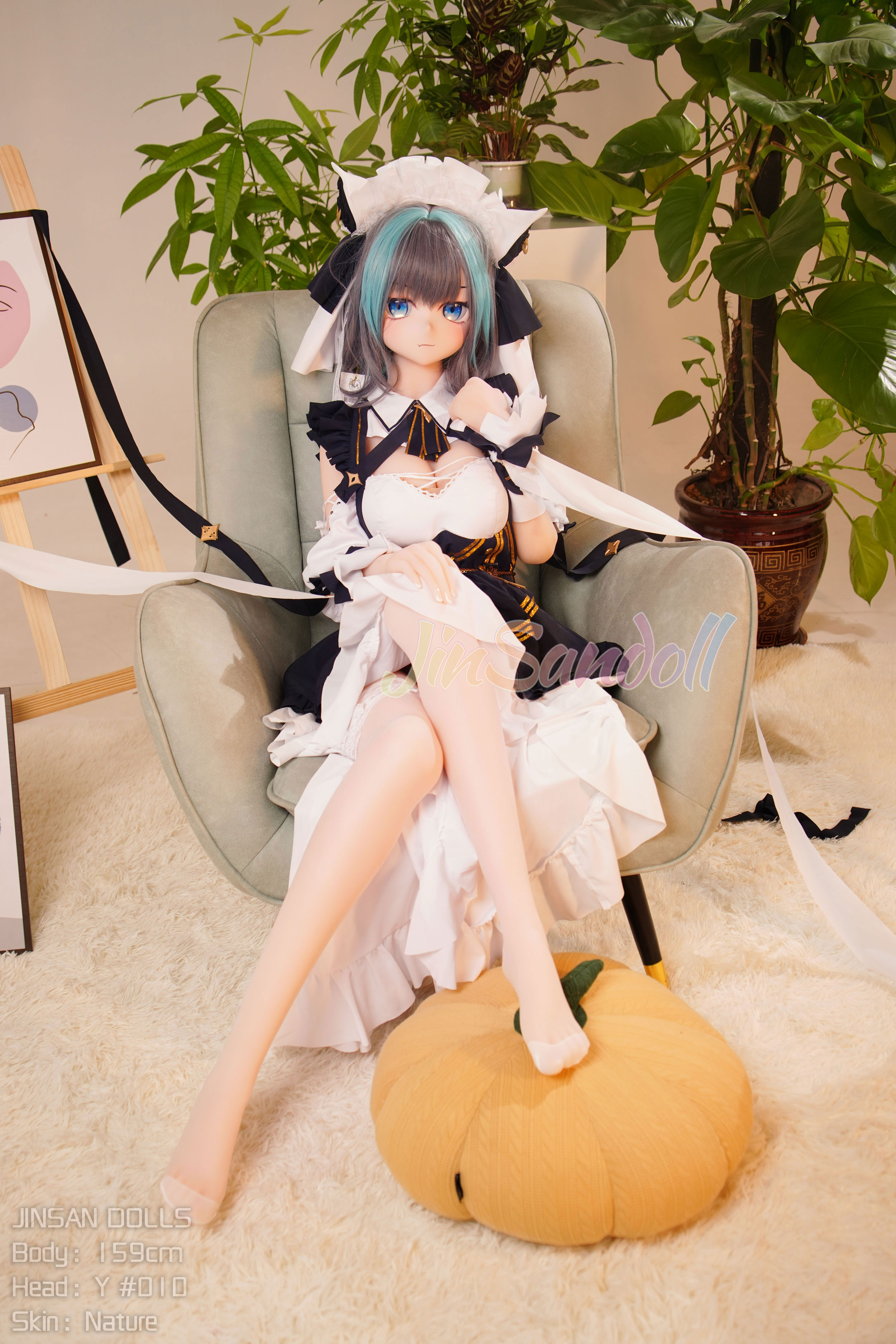 Anime sex doll Yukio in maid outfit, sitting with pumpkin