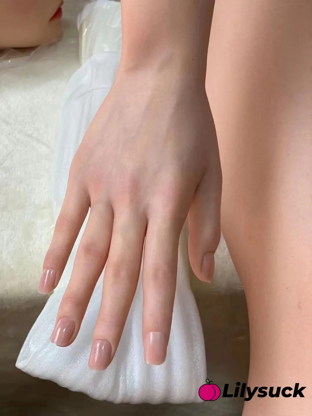 Detail of a Lilysuck doll's hand, showing the lifelike skin tone and manicured nails