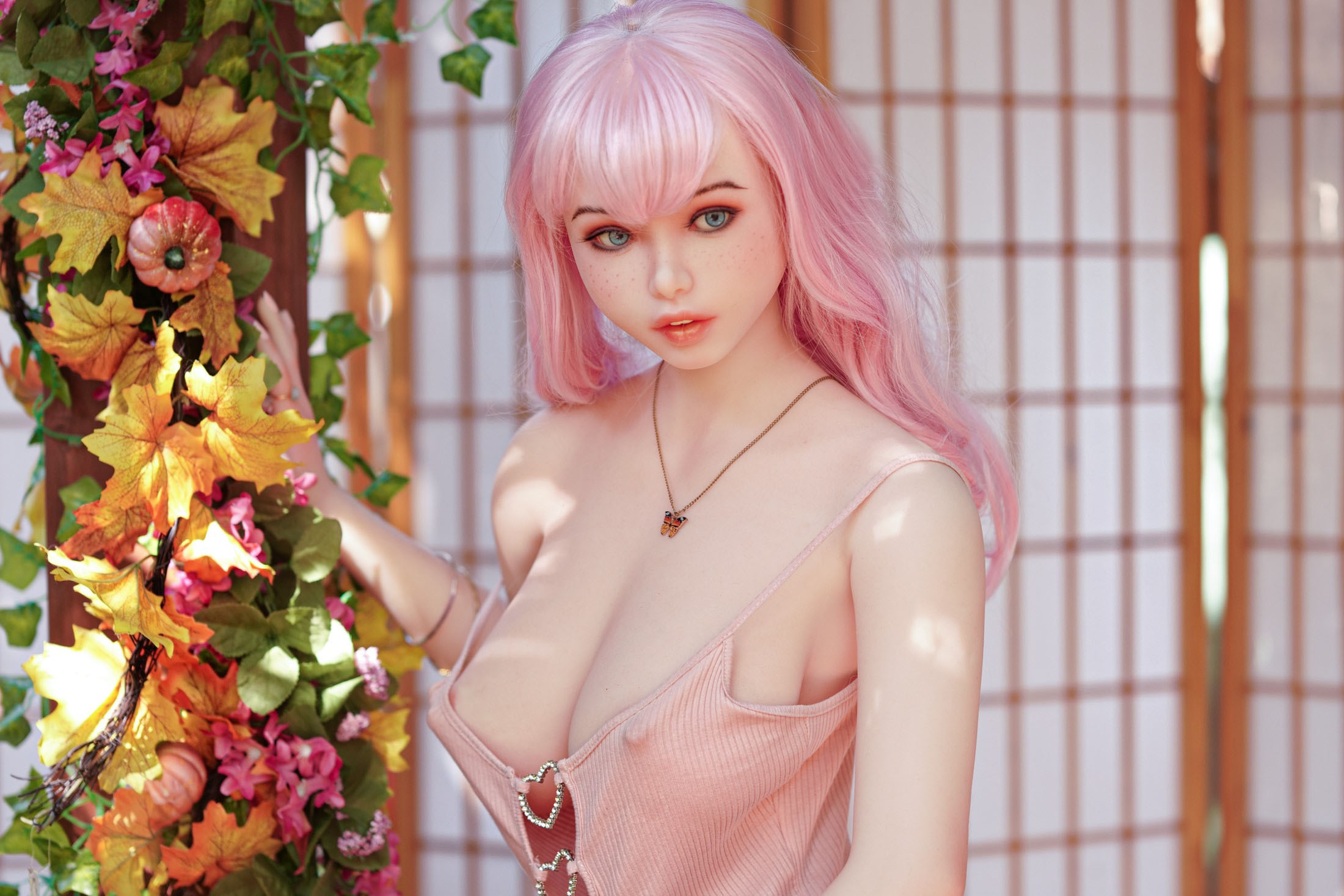 Ariel sex doll with pink hair, near flower decor