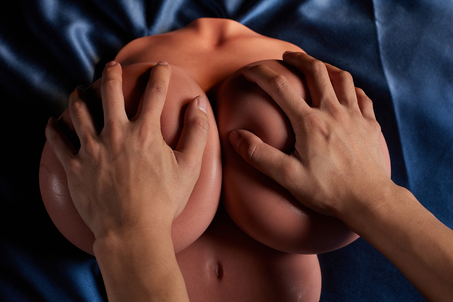 Hands caressing silicone breast sex torso