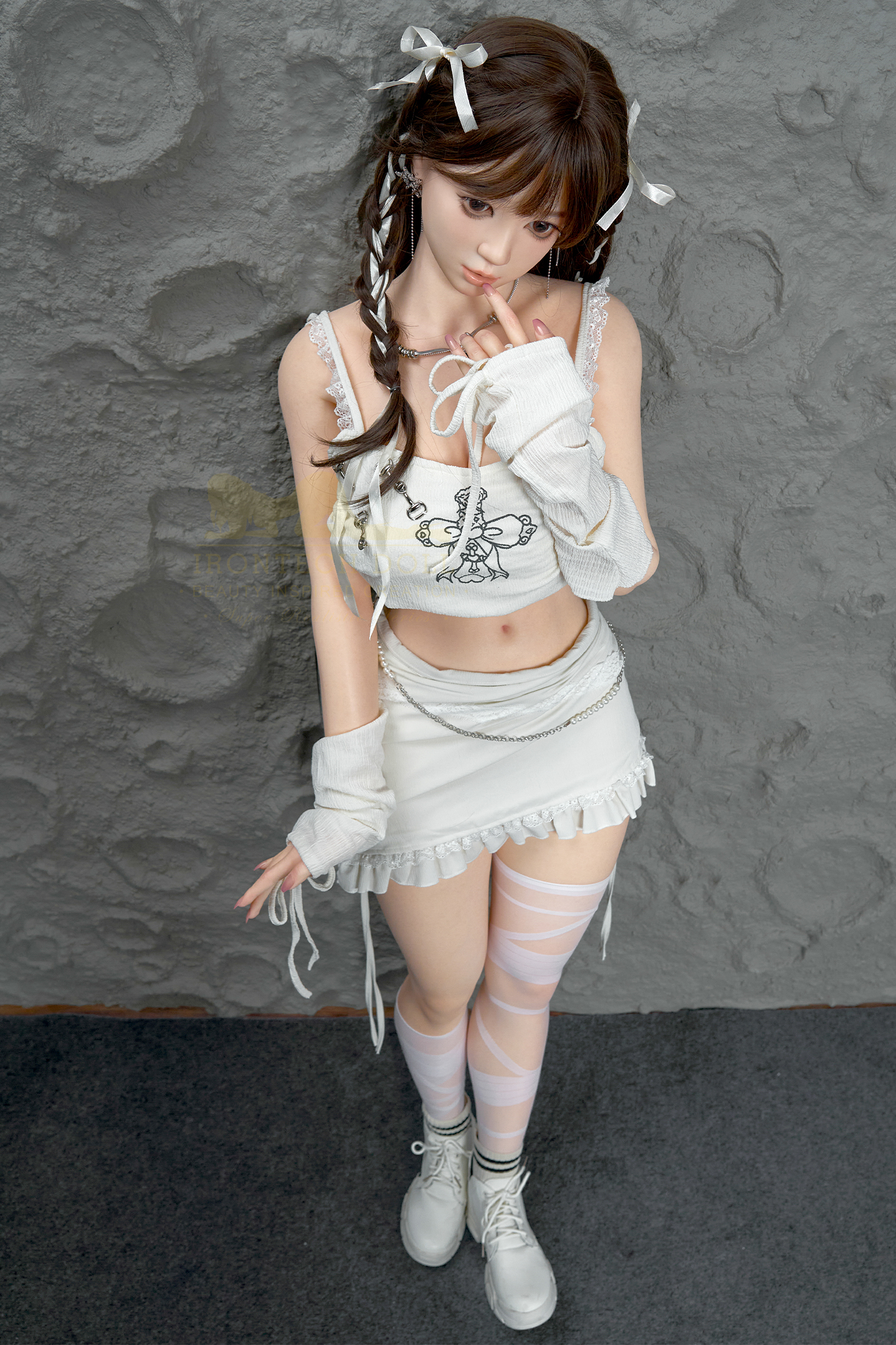 Nia doll in white outfit, playful pose, 5ft2