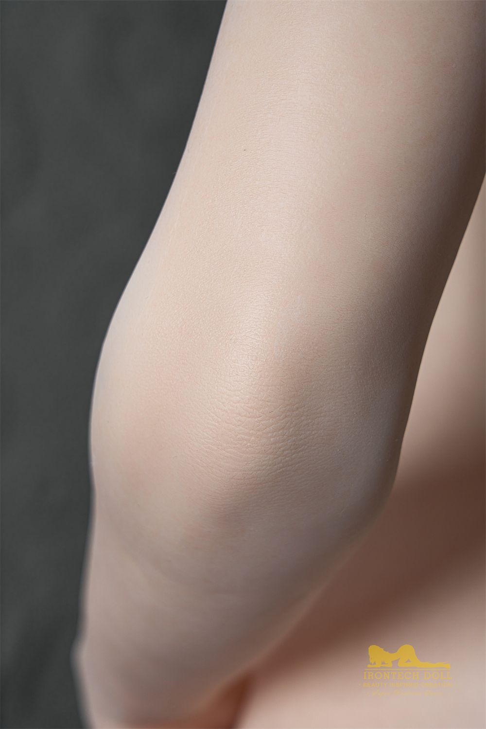 Silicone doll's knee close-up, skin texture detail