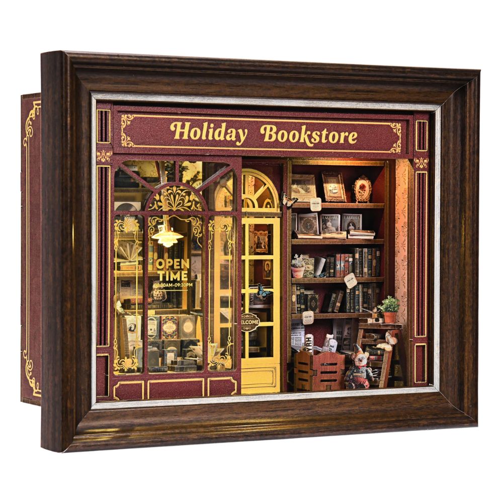 The kit creates a miniature bookstore with a vintage facade, complete with a "Holiday Bookstore" sign and "OPEN TIME" text.